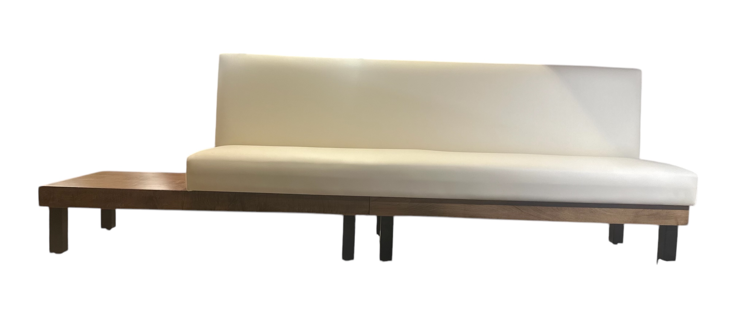 Banquette with cream cushion and wooden bench extending from left under